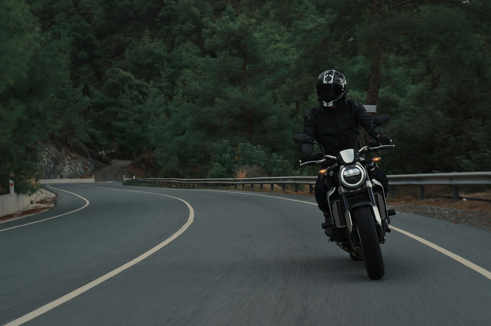 man riding motorcycle on concrete street, motorcycle
